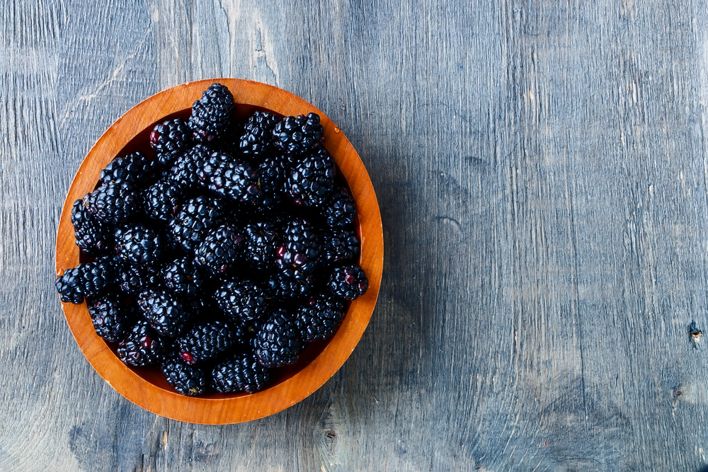 Fresh,Blackberries,In,Wooden,Bowl.,Top,View.